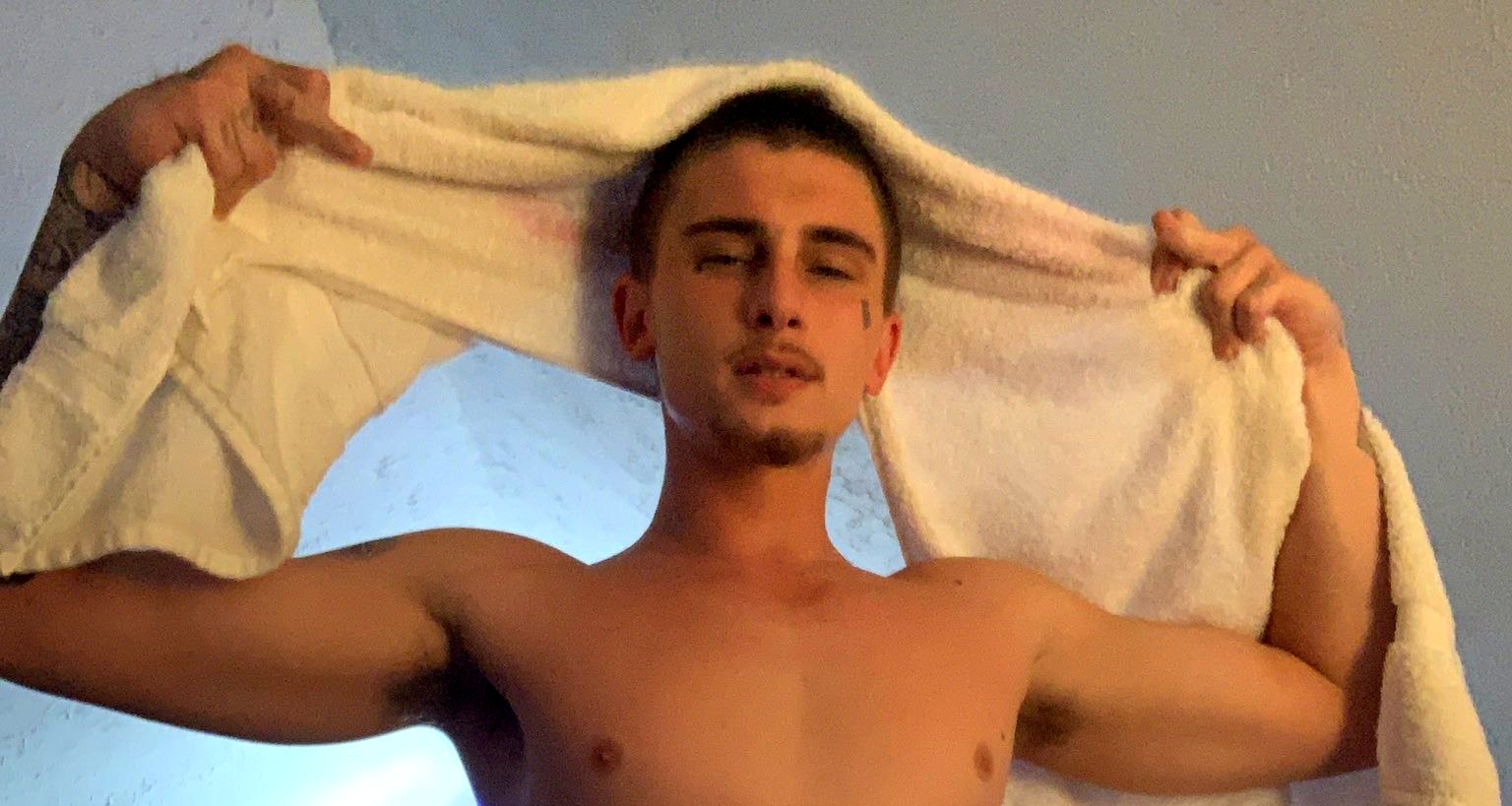 Trik pulling a towel over his head